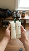 Two Everdry bags held in hands with a room background